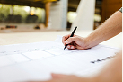 Close-up of a hand signing a document