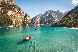 Scenic alpine lake with rowboats, shown as a travel blog thumbnail in a mock search result