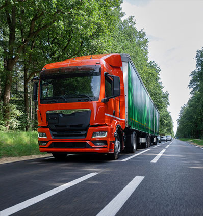 Semi-truck hauling freight on a highway, representing the B2B logistics client