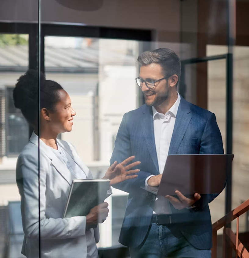Two business professionals discussing a deal in an office